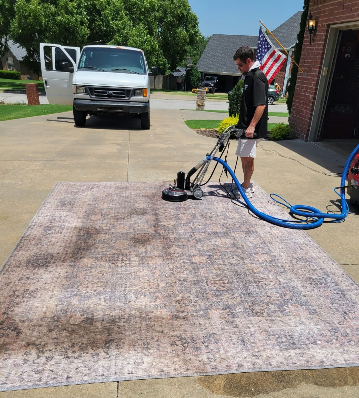 Har-Ber technician deep cleaning an area rug with a rotary machine in Northwest Arkansas